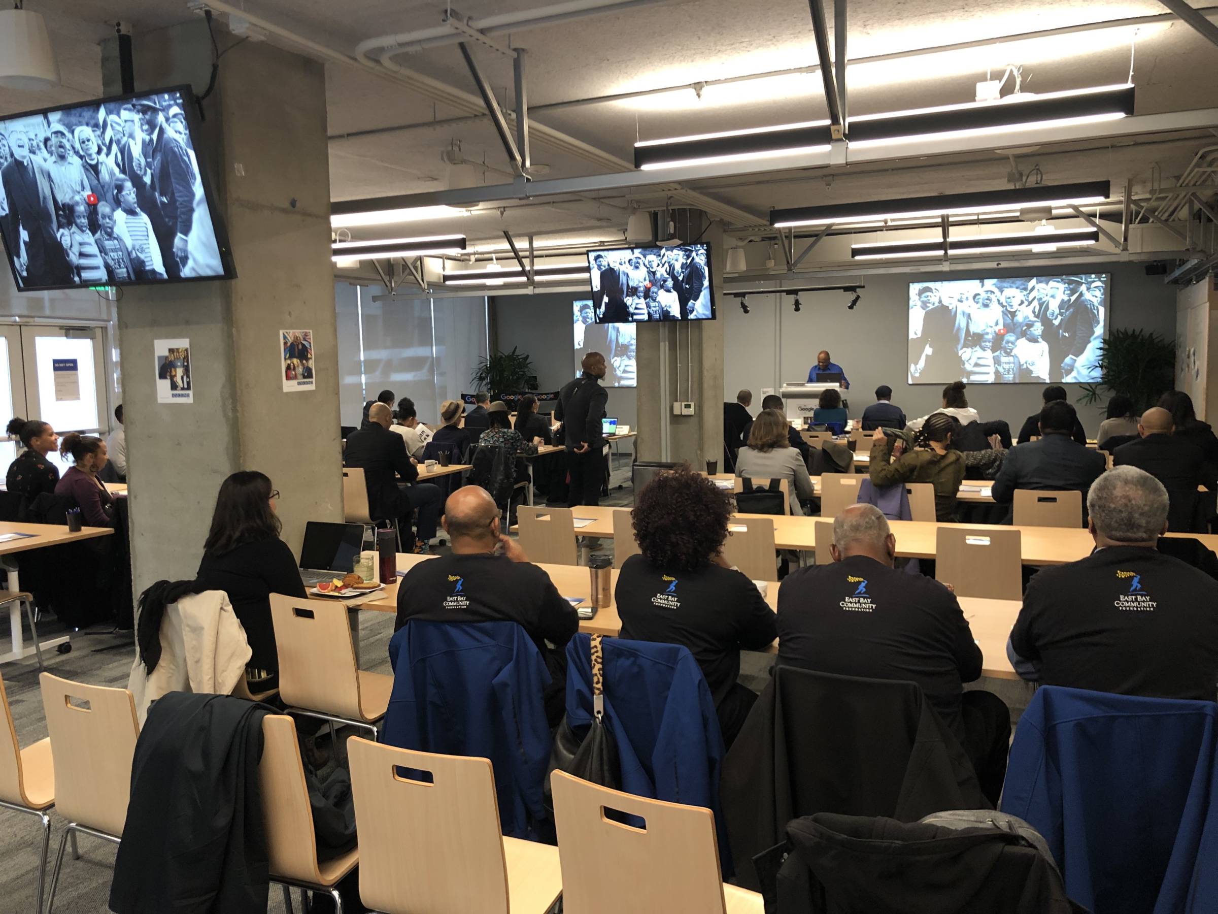 People listening to a presentation in a conference room