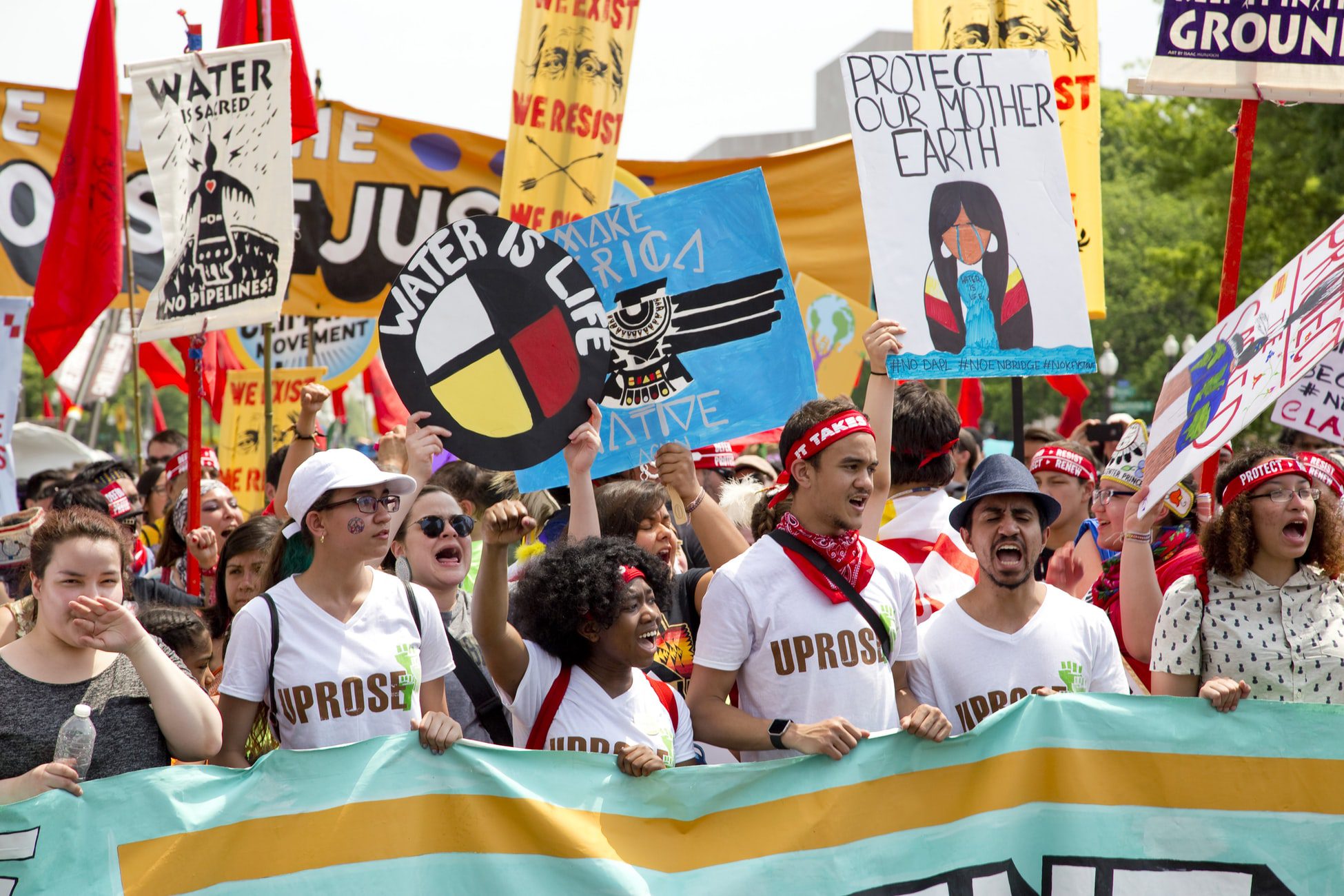 People holding signs and a banner at a protest