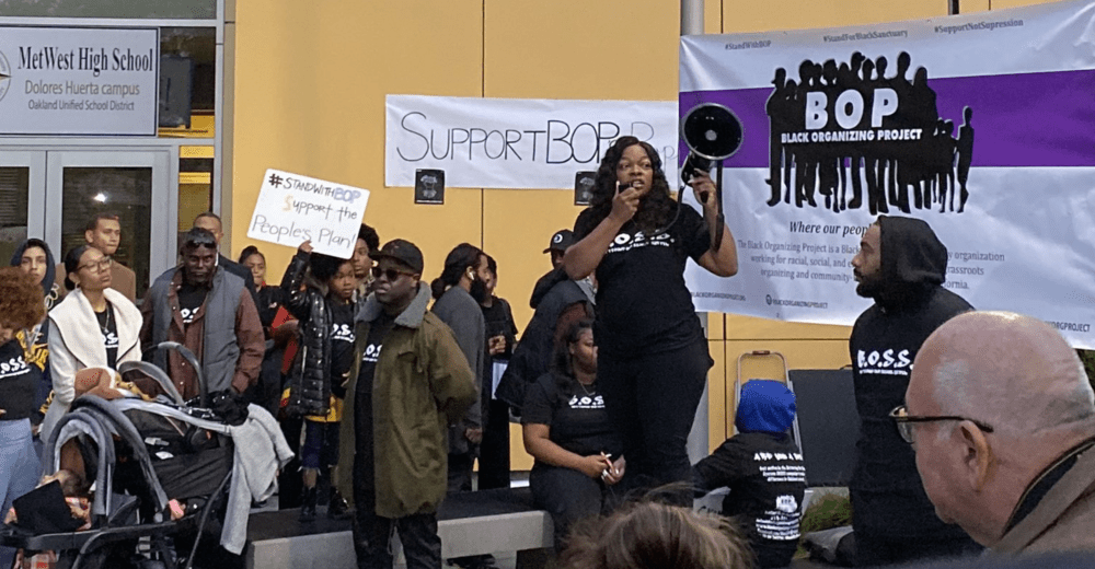 Woman speaking into a megaphone at a protest