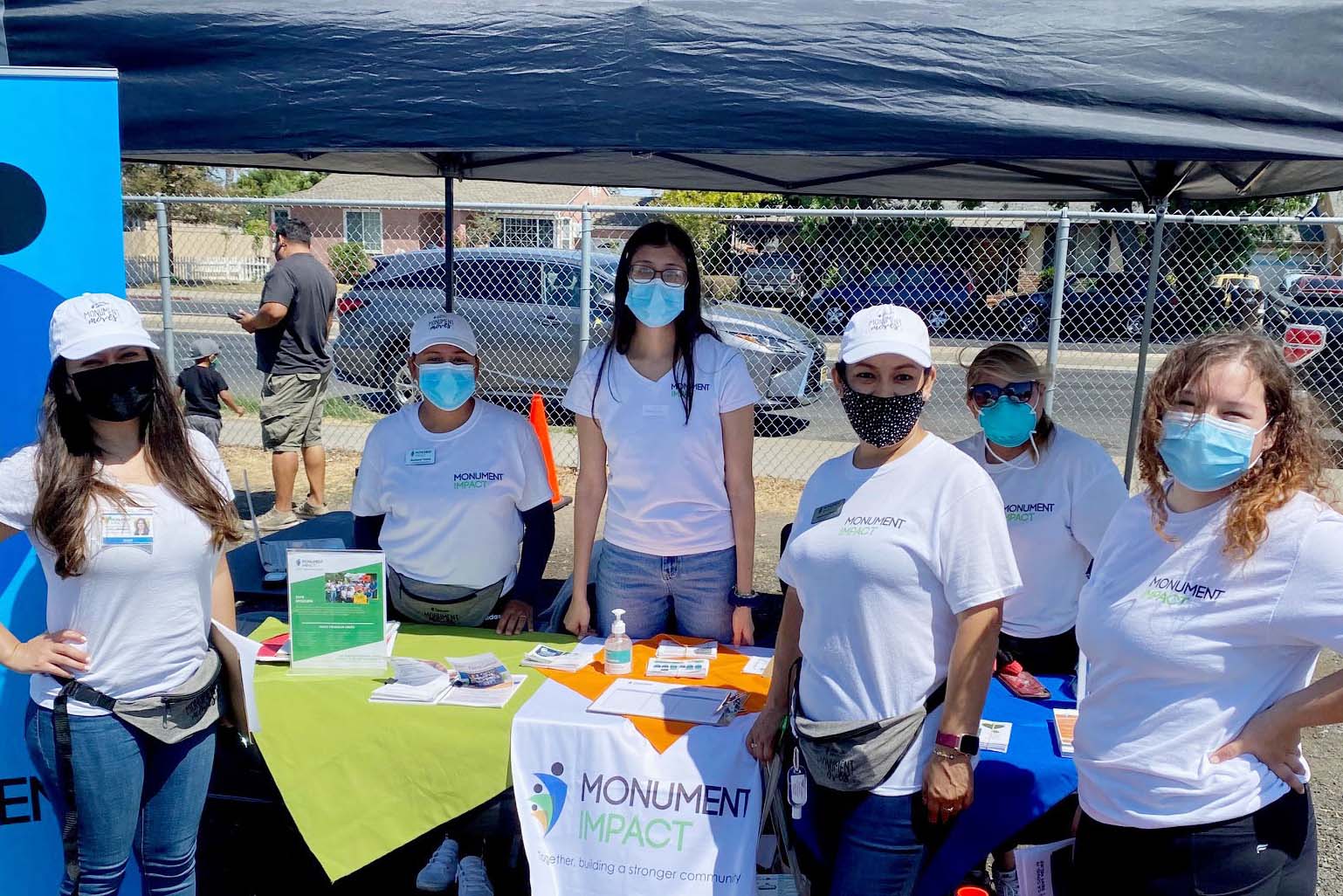 Group of people at a volunteer booth, masks