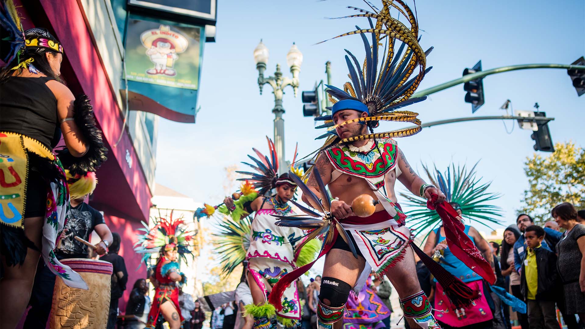 A man and woman dancing in indigenous garb