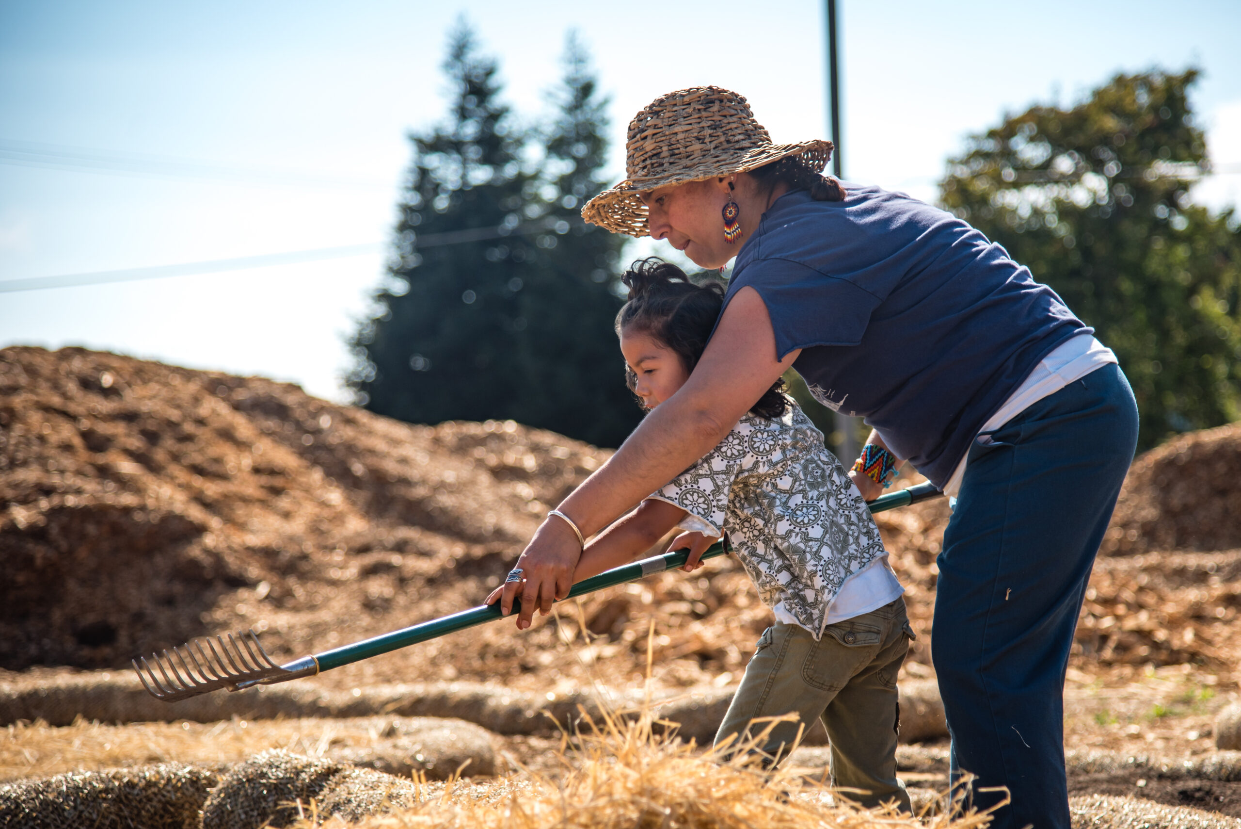 Woman with child using a rake