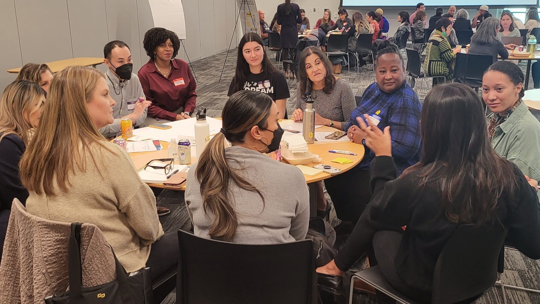 Residents in discussion around a table at a community convening