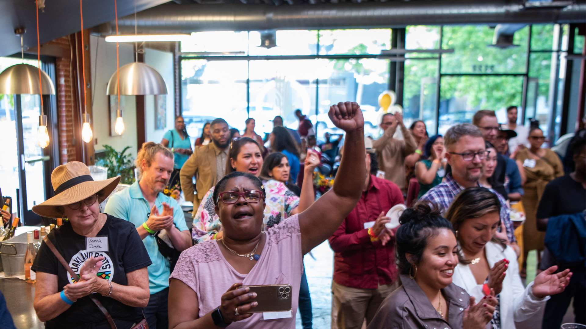 A group of event attendees cheers